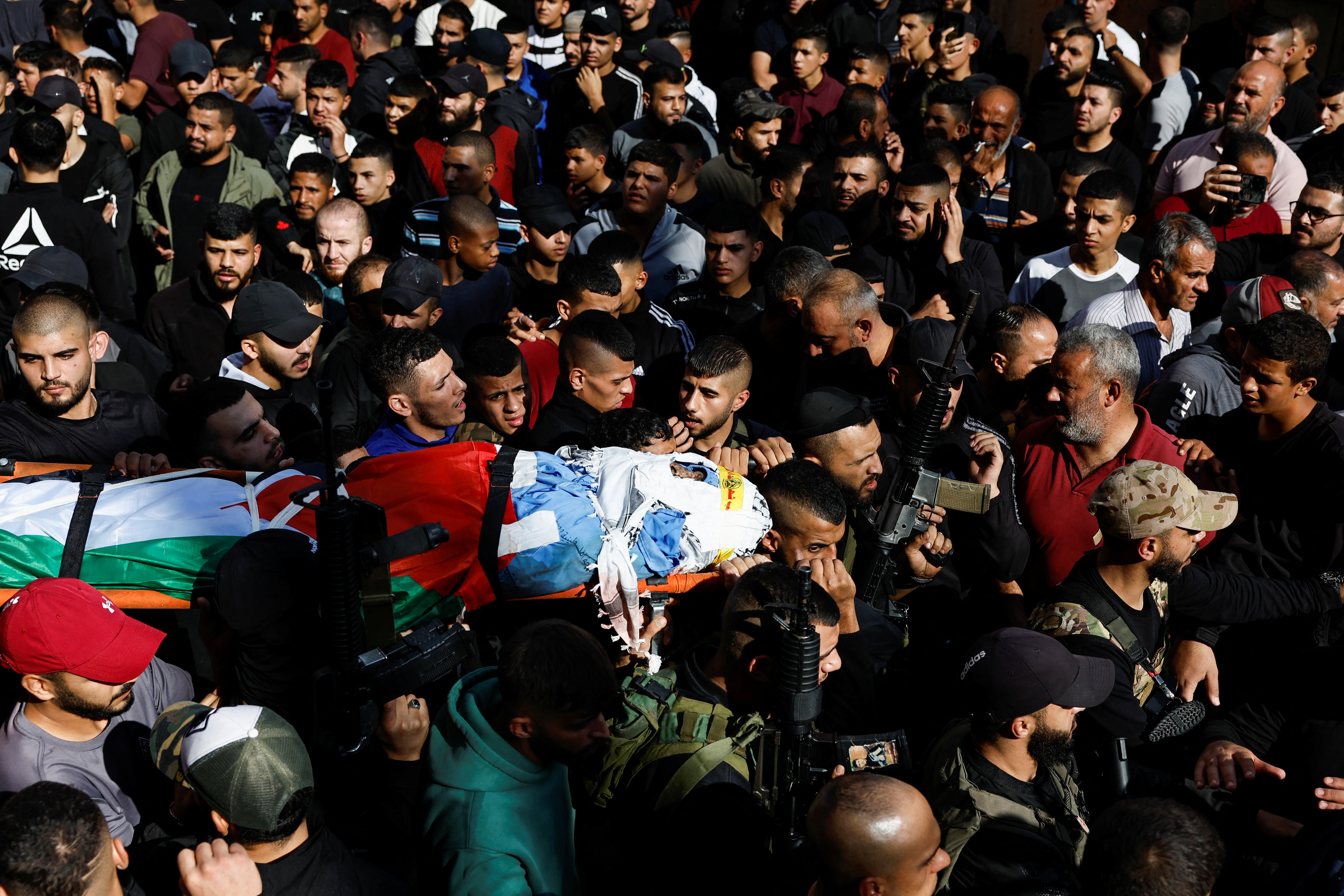 People attend the funeral of five Palestinian fighters  who were killed in an Israeli air strike in the Balata Camp, in Nablus