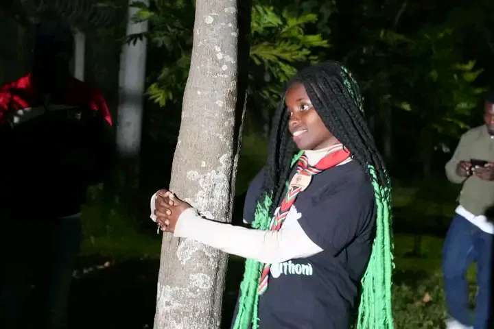 Kenyan climate activist Truphena Muthoni hugging a tree