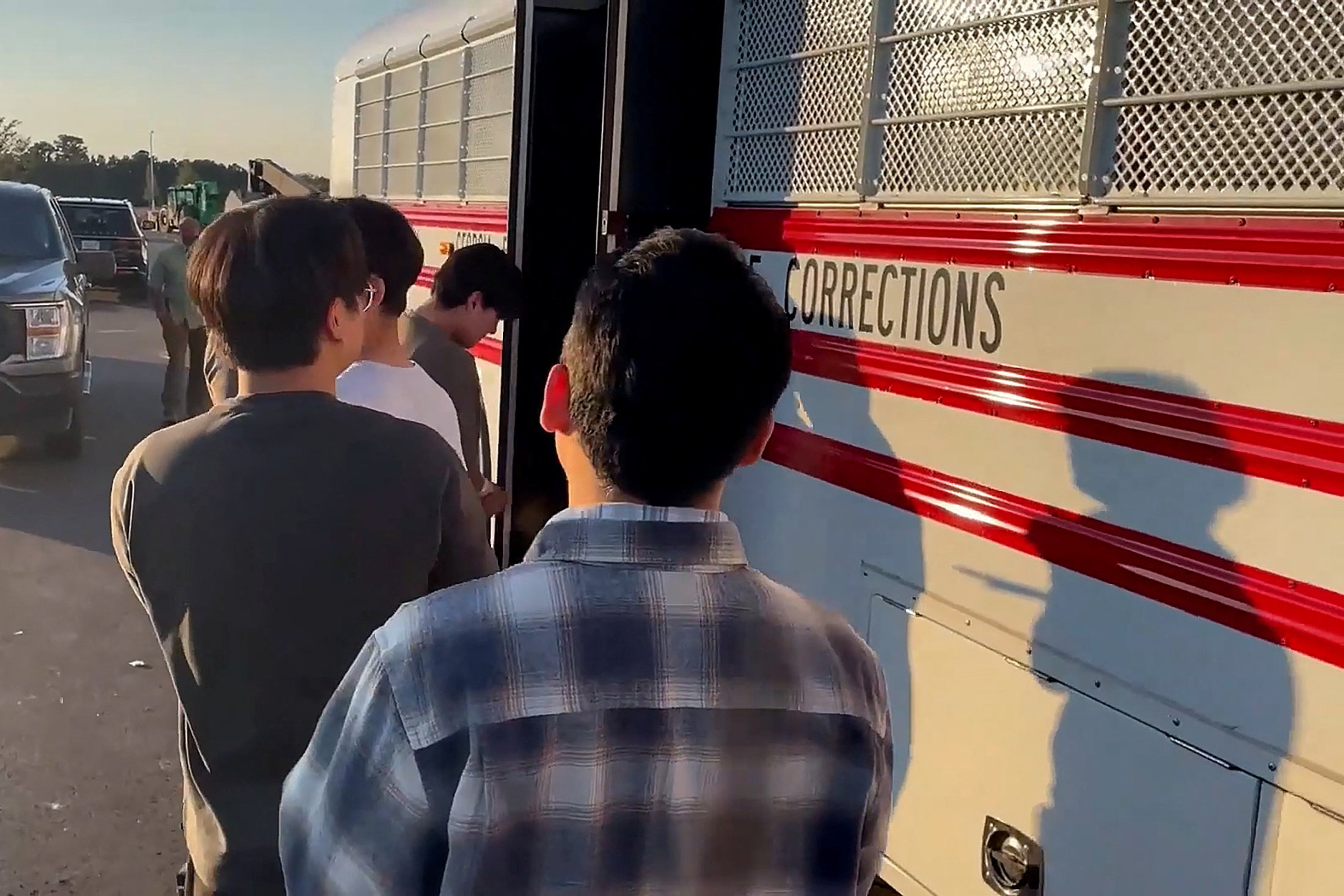 Detainees board a bus during a raid by federal agents in Ellabell