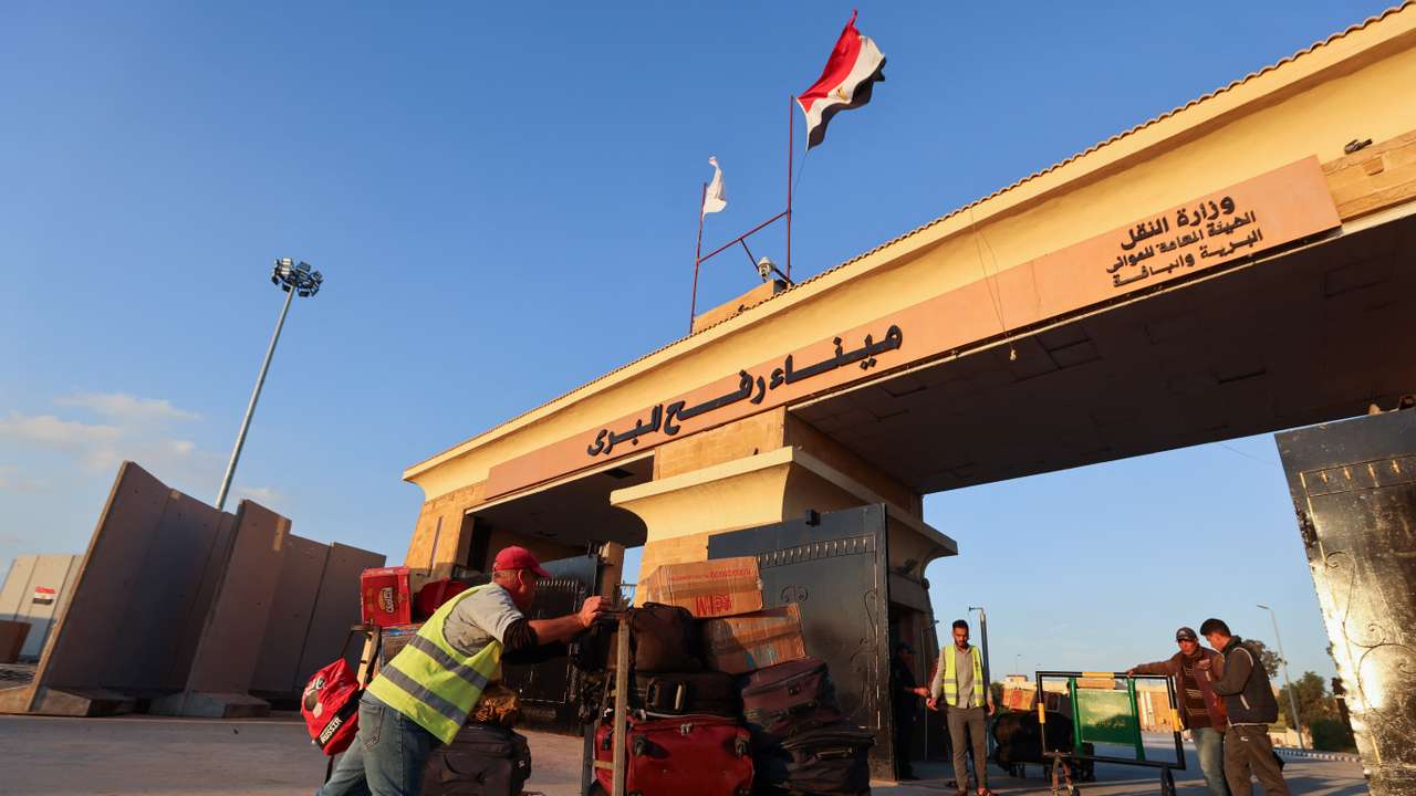 Ambulances drive on the Egyptian side of the Rafah border crossing between Egypt and the Gaza Strip