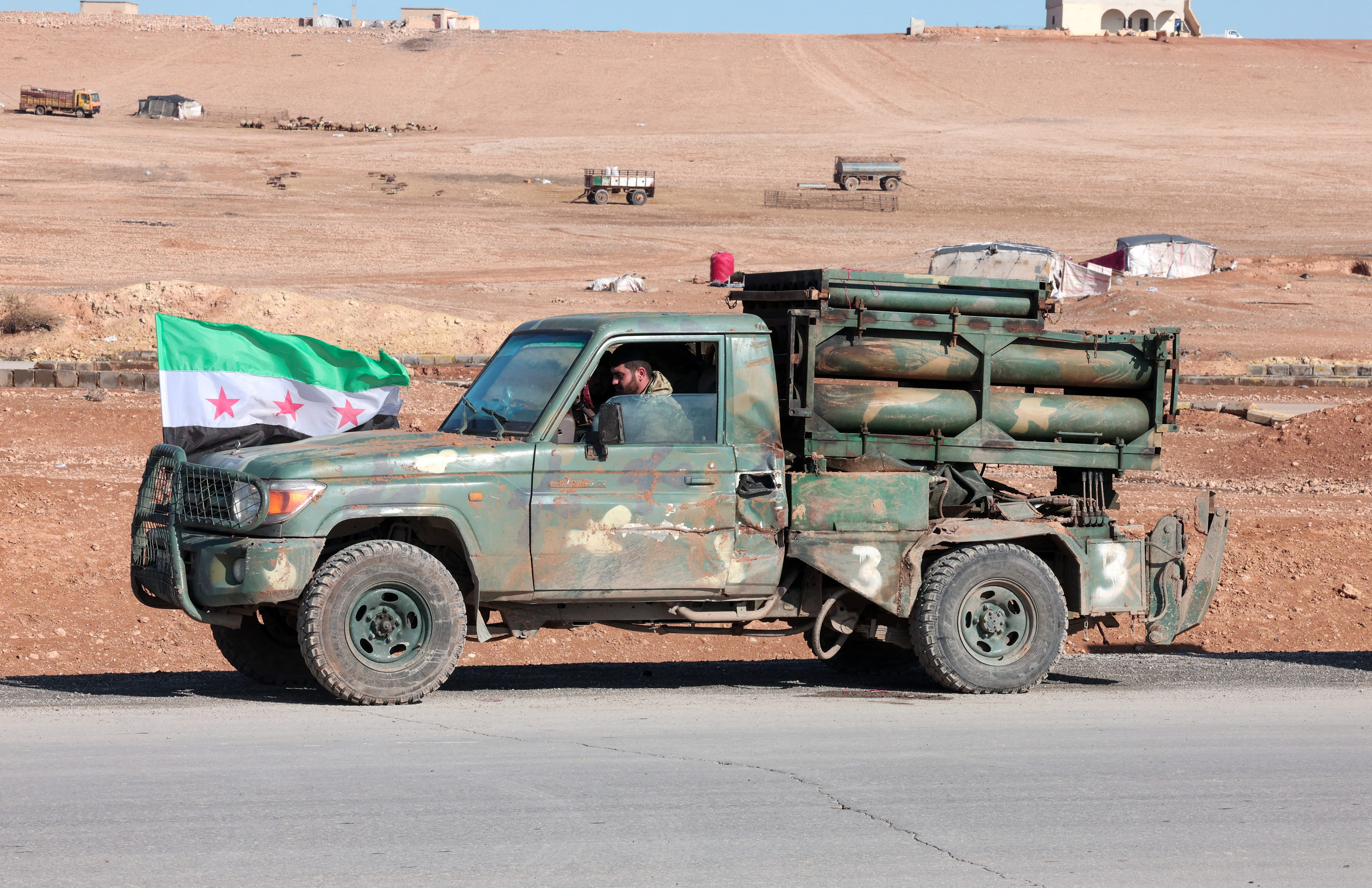 A military vehicle of the Syrian army is parked on the highway near Tabqa