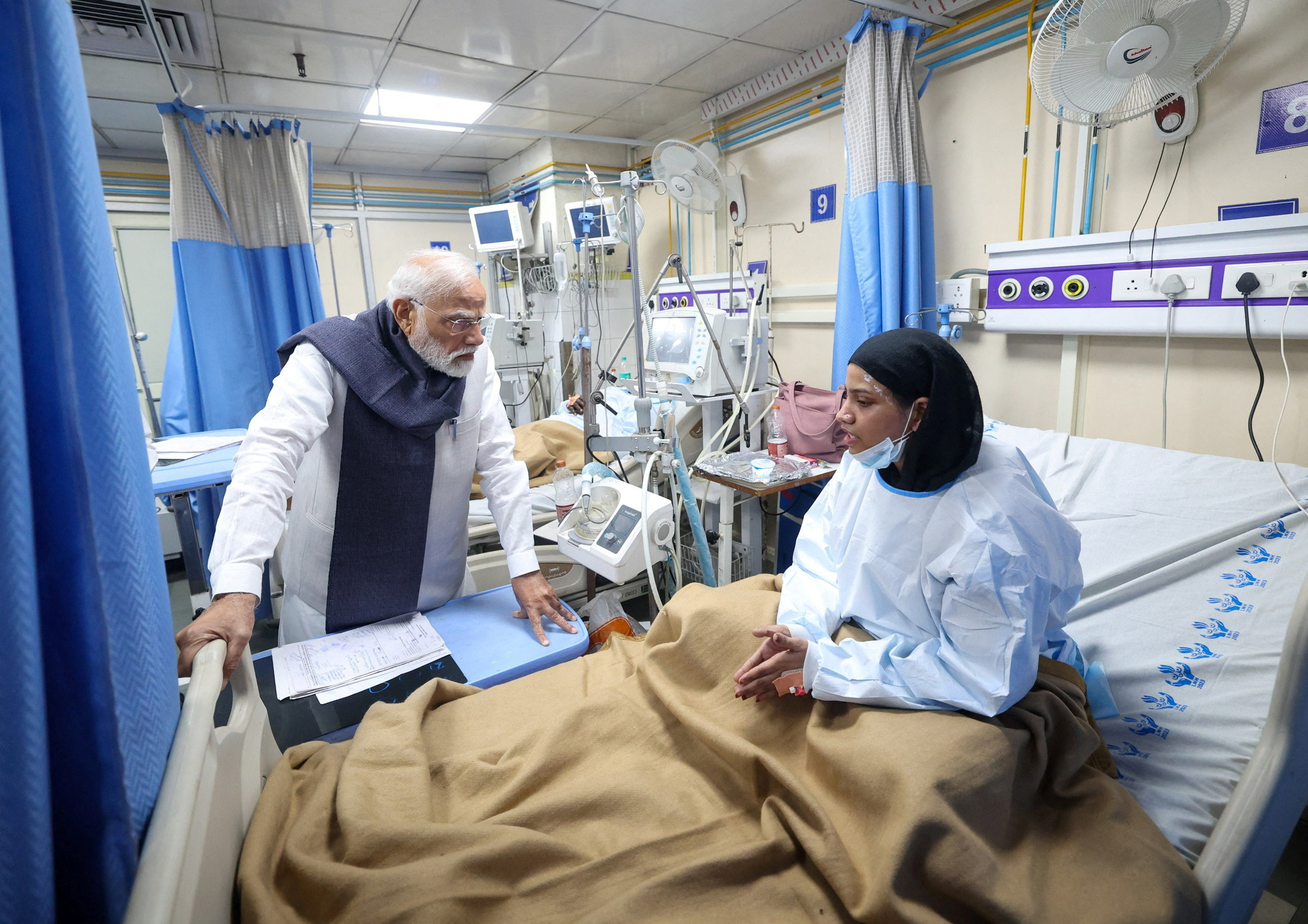 India's PM Modi speaks with a woman, who was injured in an explosion near the historic Red Fort in the old quarters of Delhi on Monday, at LNJP Hospital in New Delhi