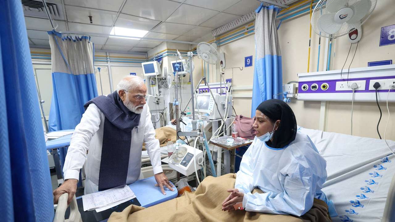 India's PM Modi speaks with a woman, who was injured in an explosion near the historic Red Fort in the old quarters of Delhi on Monday, at LNJP Hospital in New Delhi