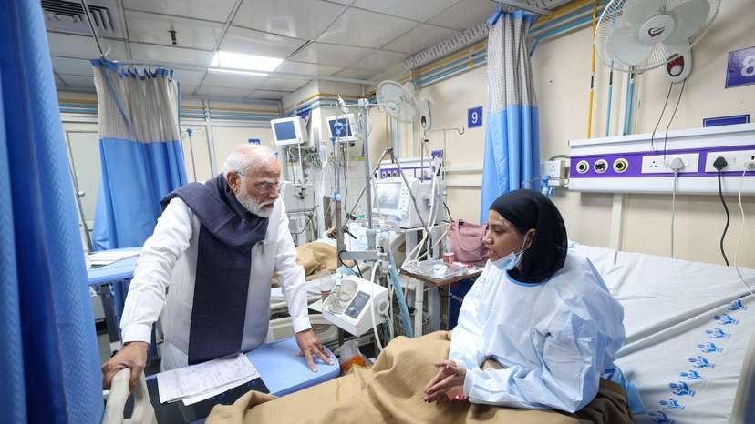 India's PM Modi speaks with a woman, who was injured in an explosion near the historic Red Fort in the old quarters of Delhi on Monday, at LNJP Hospital in New Delhi
