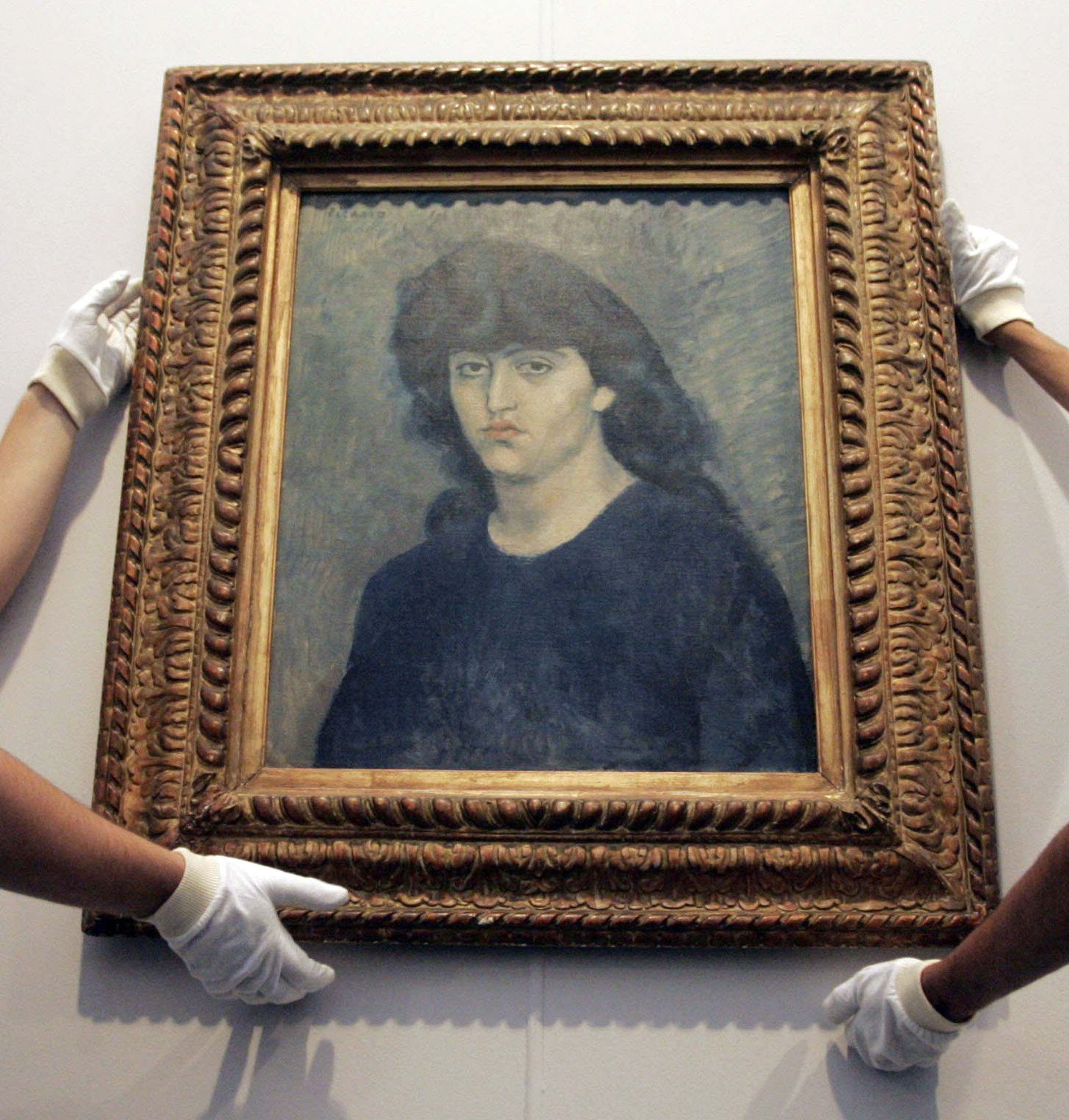 Sao Paulo Museum of Art workers hang Pablo Picasso's oil painting ''Portrait of 'Suzanne Bloch'' before the Museum re-open to visitors