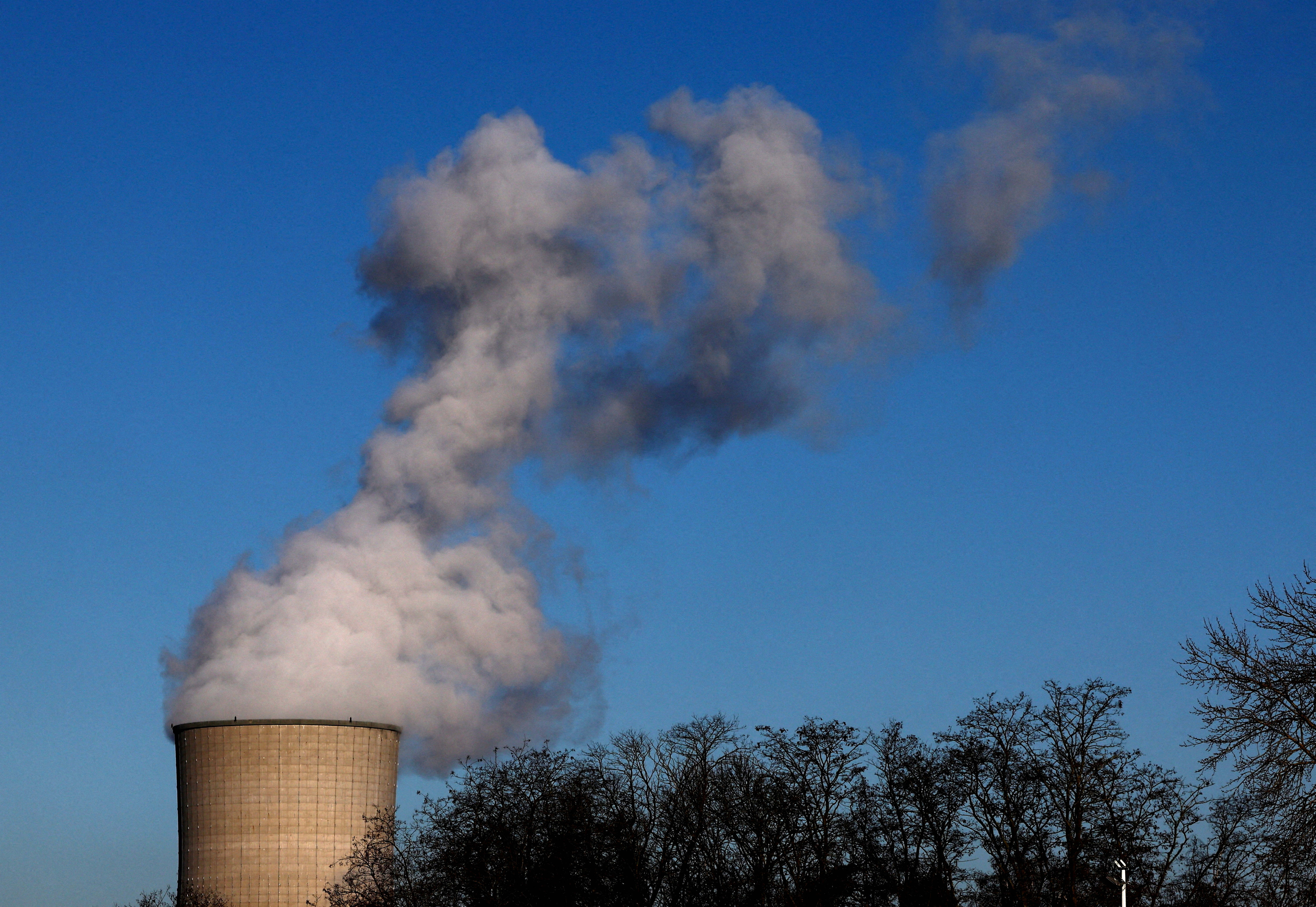 FILE PHOTO: Smoke billows from a chimney at a combined-cycle gas turbine power plant in Drogenbos