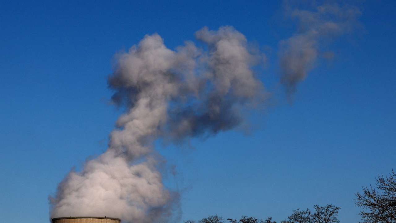 FILE PHOTO: Smoke billows from a chimney at a combined-cycle gas turbine power plant in Drogenbos