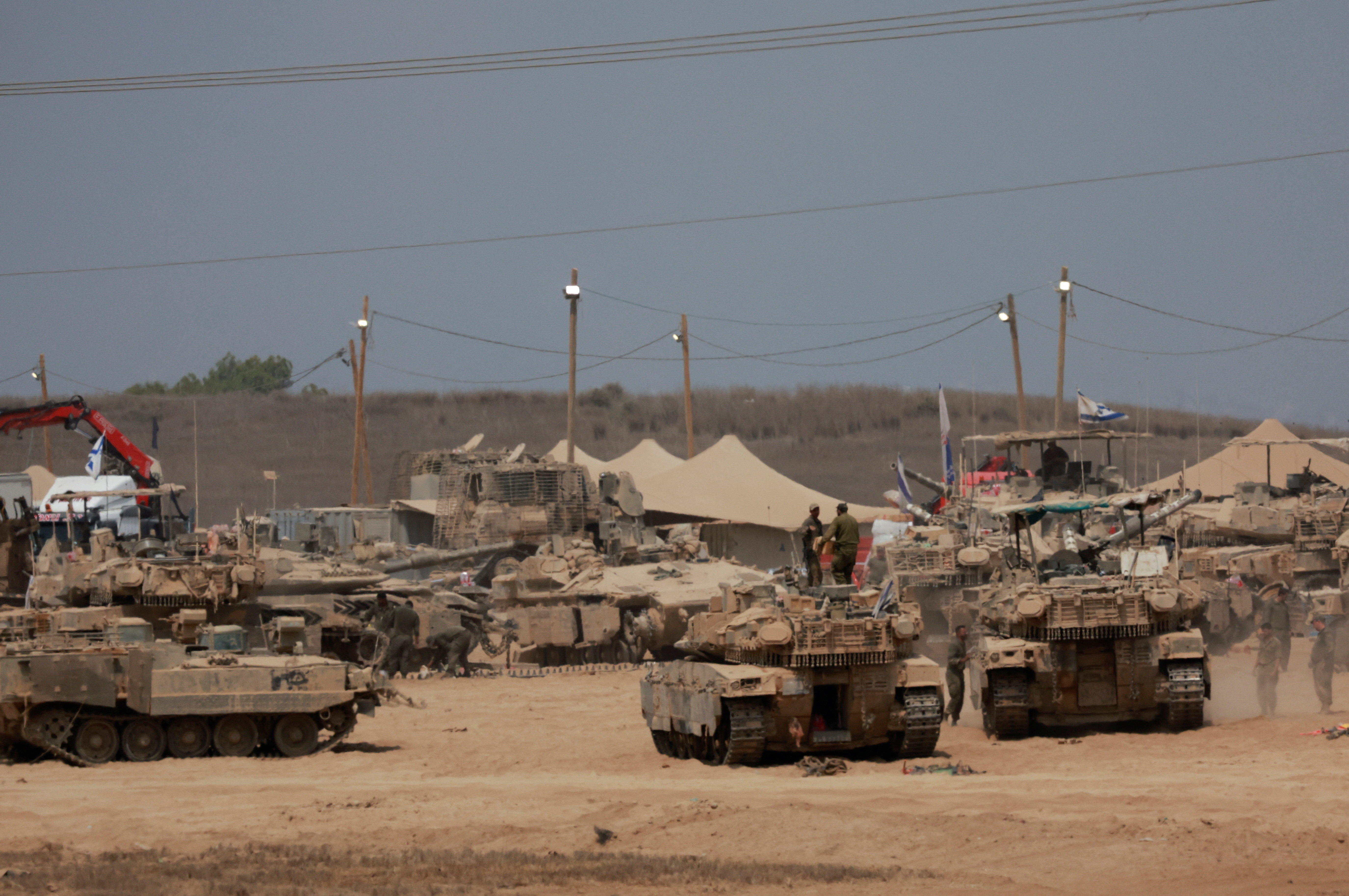 Military vehicles on the Israeli side of the border with Gaza, as seen from Israel