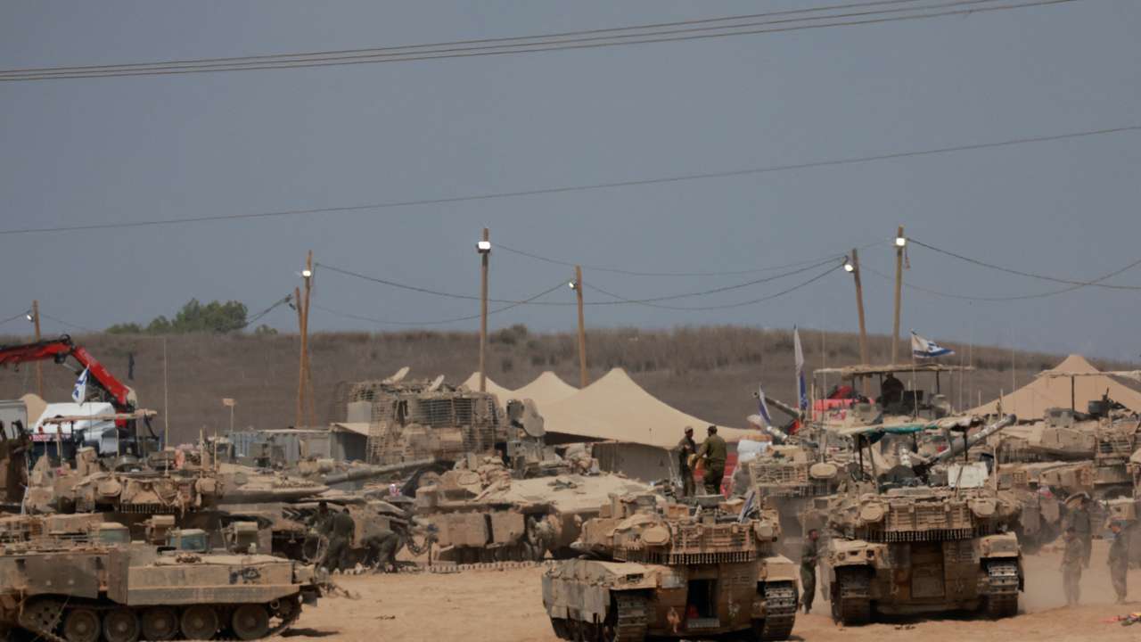 Military vehicles on the Israeli side of the border with Gaza, as seen from Israel