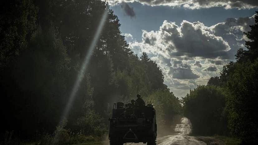 FILE PHOTO: Ukrainian servicemen ride a military vehicle near the Russian border in Sumy region