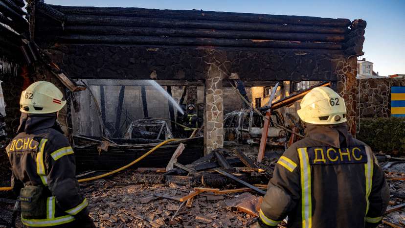 Firefighters work at a site of a Russian drone strike in Kyiv