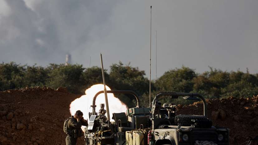 FILE PHOTO: Israeli soldiers fire a mortar, amid the Israel-Hamas conflict, near the Israel-Gaza border