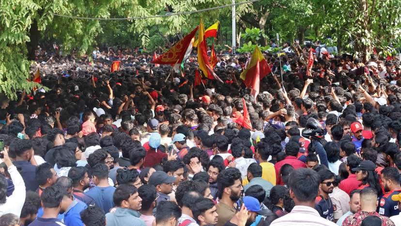 People gather to celebrate Royal Challengers Bengaluru's first Indian Premier League (IPL) title win, outside a cricket stadium in Bengaluru
