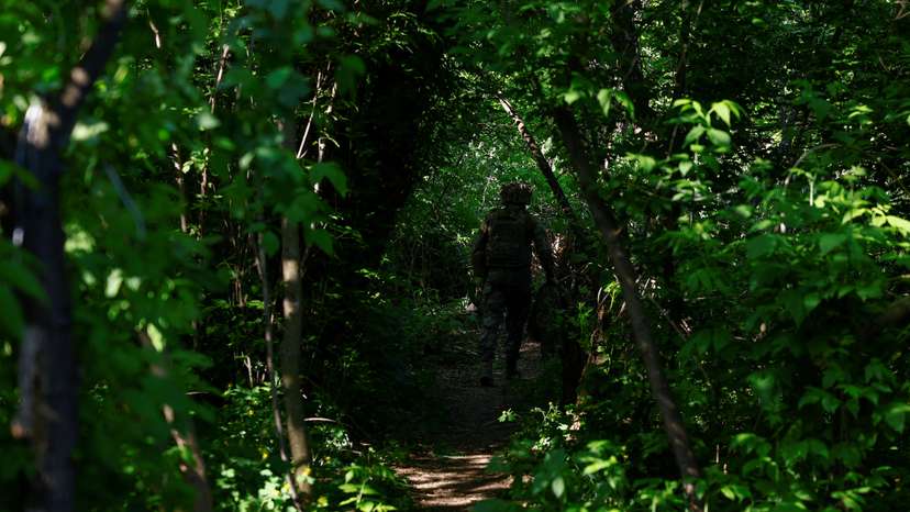 walks at a position after firing a howitzer toward Russian troops near a front line in Donetsk region