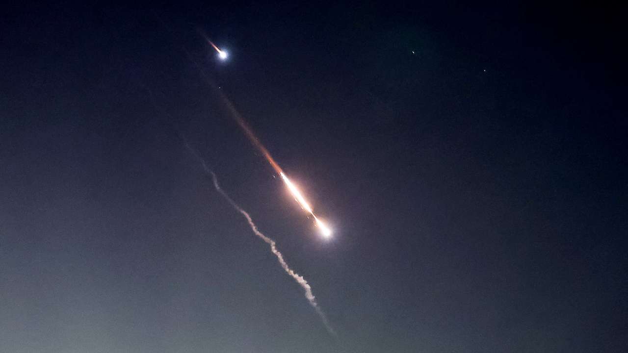 Objects are seen in the sky above Jerusalem after Iran launched drones and missiles towards Israel, in Jerusalem