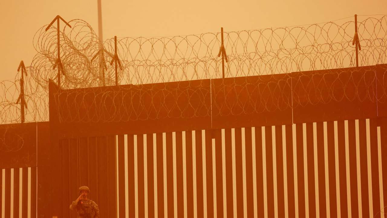 FILE PHOTO: A Texas National Guard soldier stands near the wall on the border between Mexico and U.S. during a sandstorm