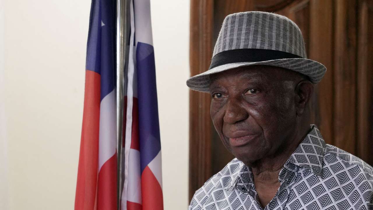 FILE PHOTO: Liberia president-elect Joseph Boakai looks on next to a Liberian flag, in Monrovia