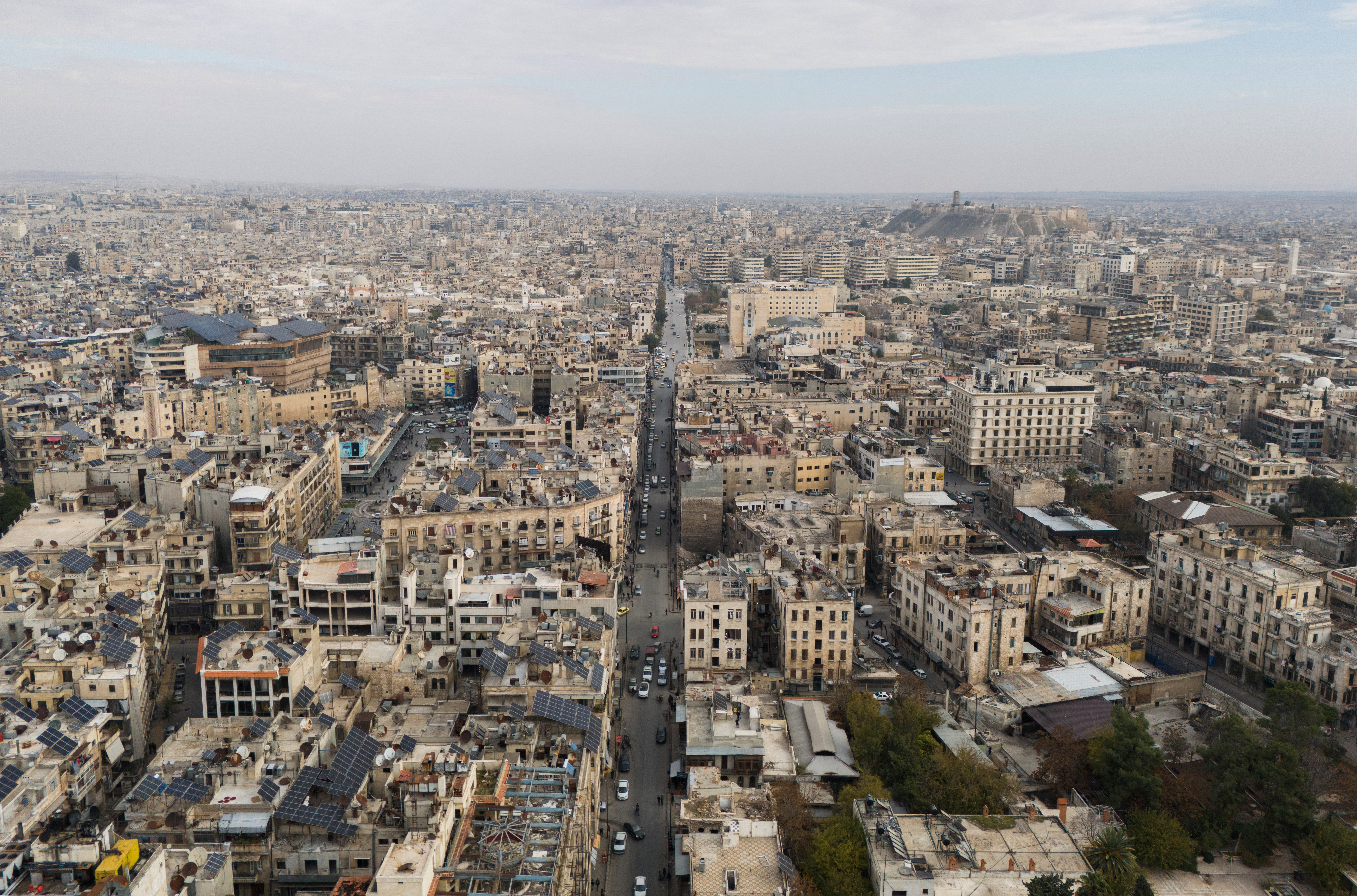 A drone view shows residential buildings and Aleppo's ancient citadel