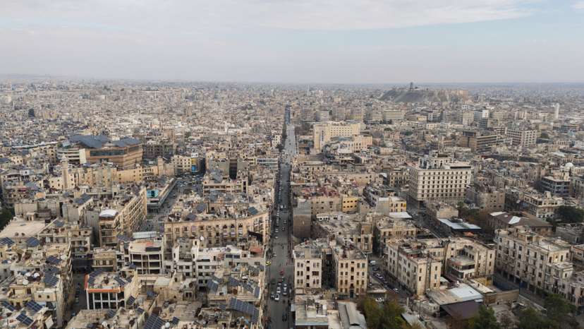 A drone view shows residential buildings and Aleppo's ancient citadel