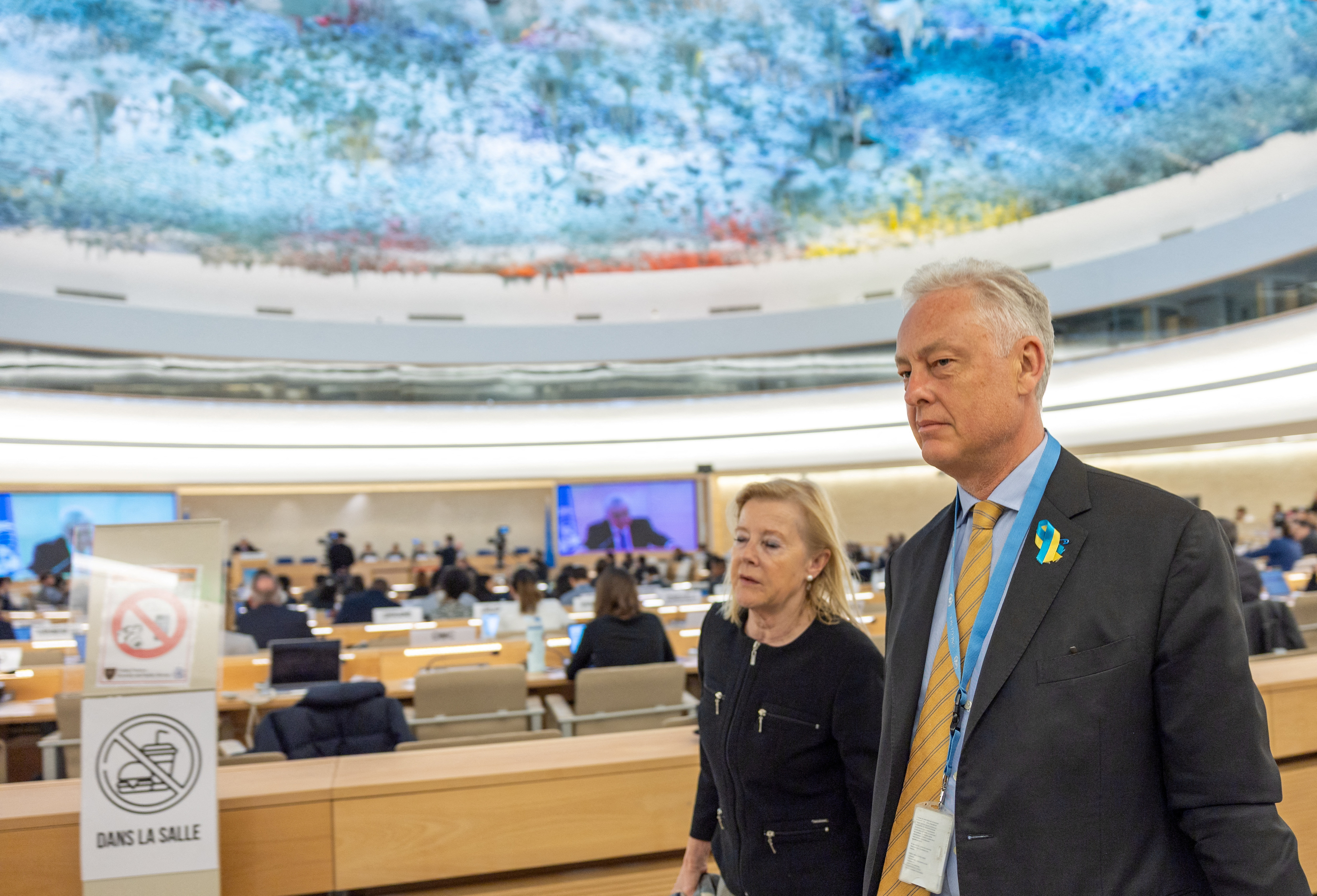 Britain's ambassador to the U.N. Manley walks out with other delegates during the speech of Vershinin, Deputy Minister of Foreign Affairs of Russia at the Human Rights Council in Geneva