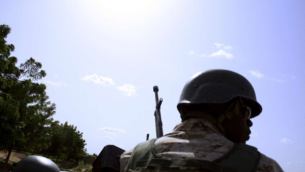 FILE PHOTO: A soldier from Niger escorts U.S. soldiers back to their base