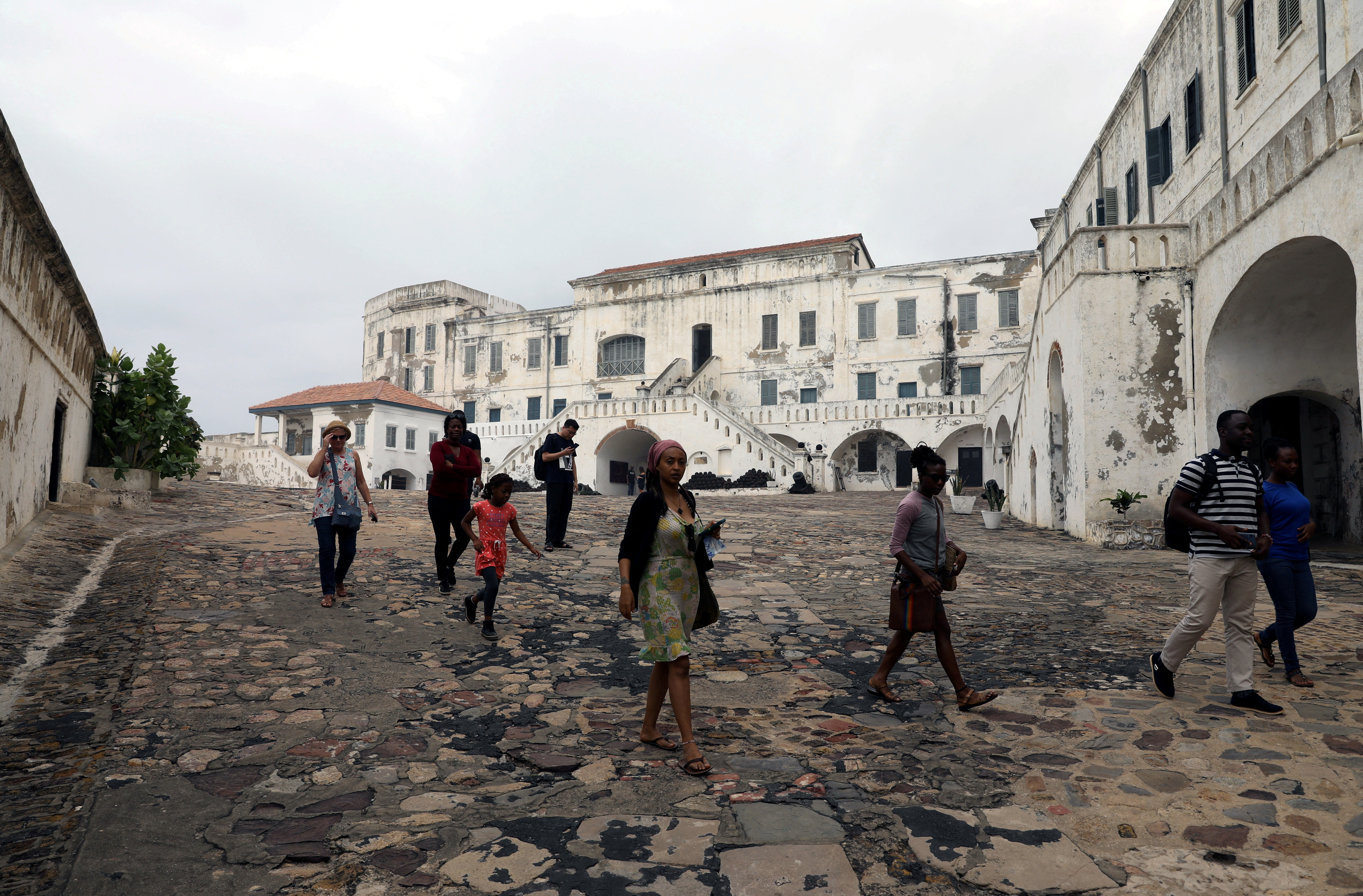 FILE PHOTO: Tourists are seen at the Cape Coast Castle one of several slave forts build on the Gold Coast off Cape Coast