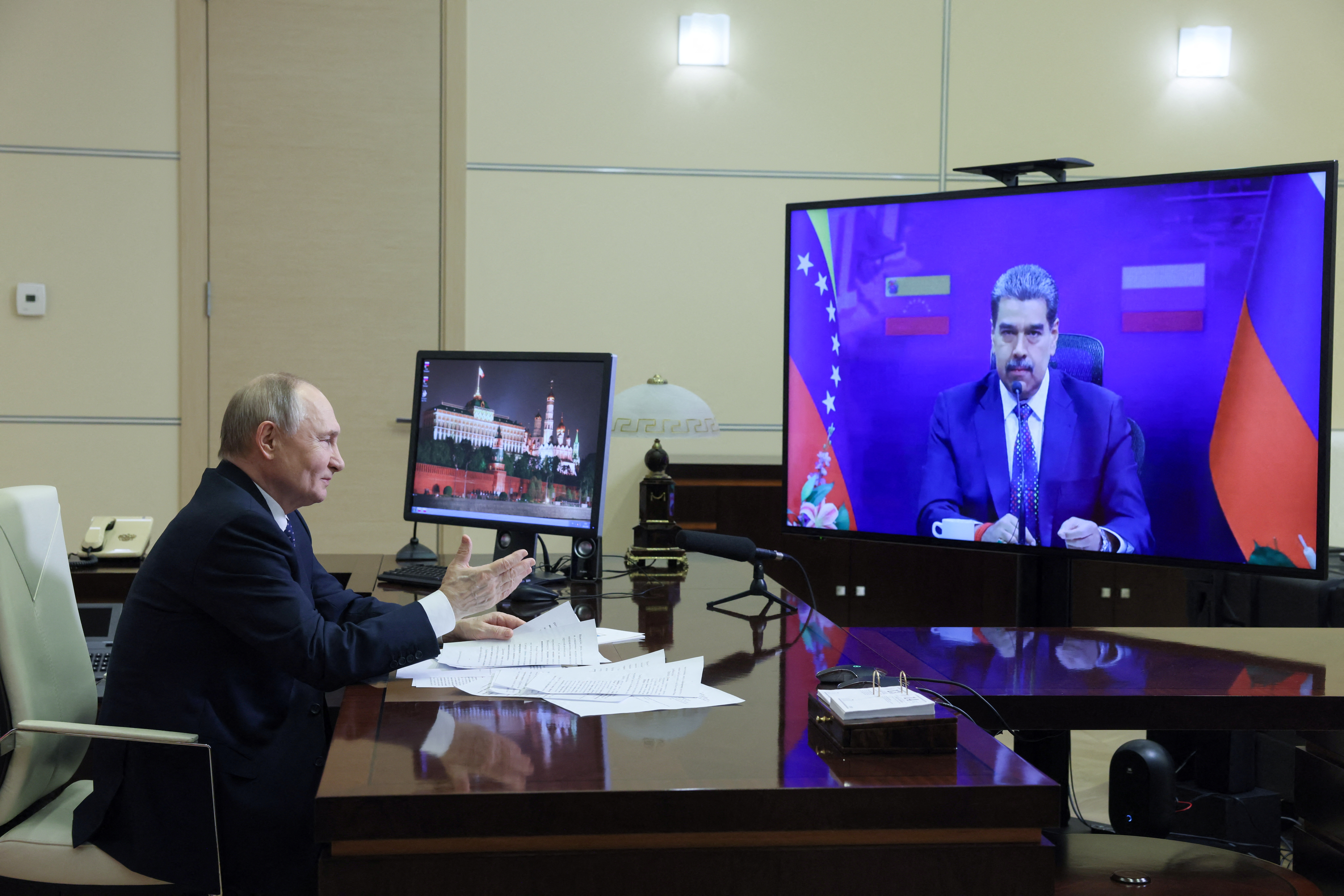 Russian President Vladimir Putin attends a meeting with Venezuelan President Nicolas Maduro via video link outside Moscow
