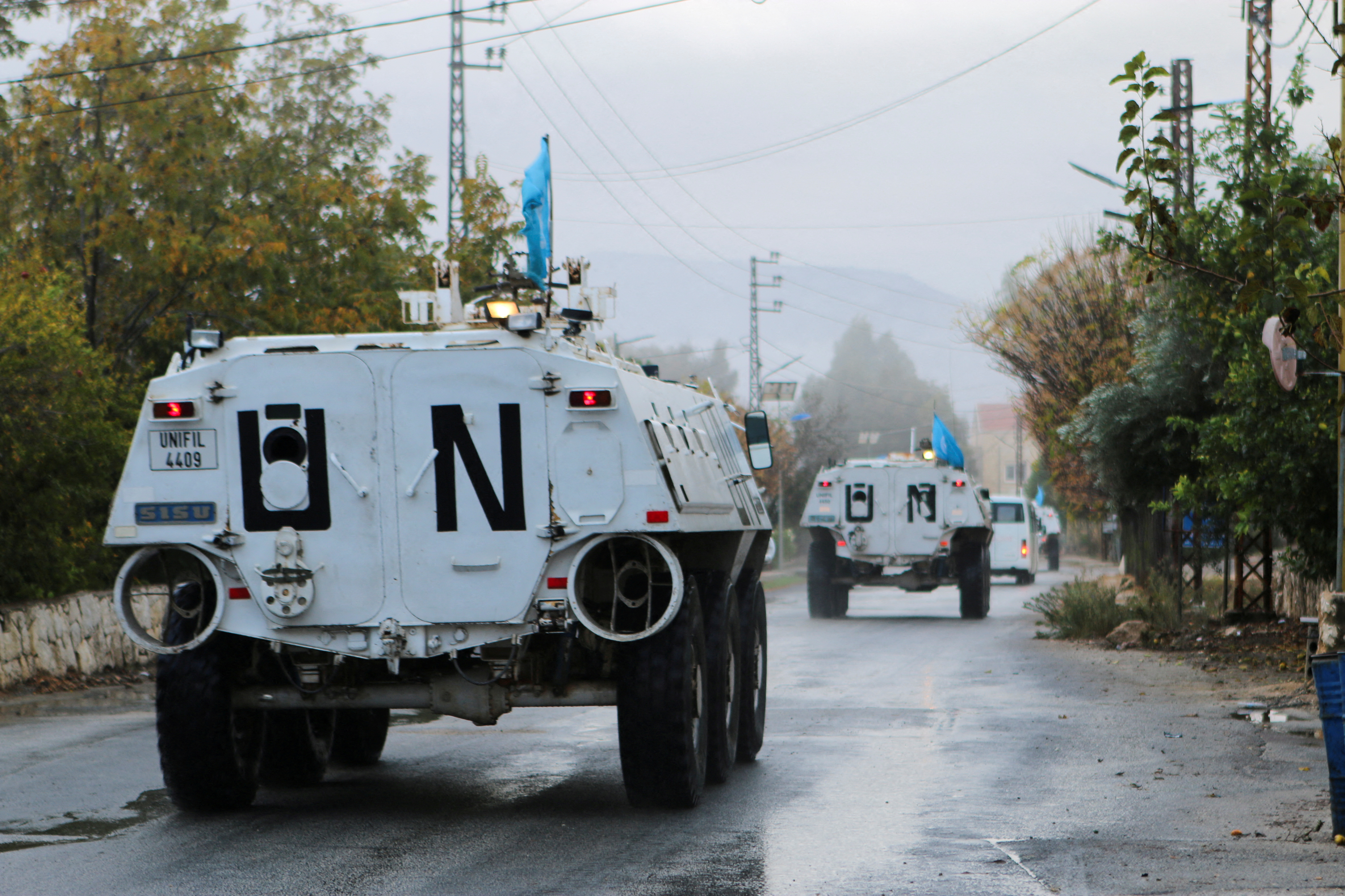 FILE PHOTO: UN peacekeepers (UNIFIL) vehicles ride along a street amid ongoing hostilities between Hezbollah and Israeli forces, in Marjayoun