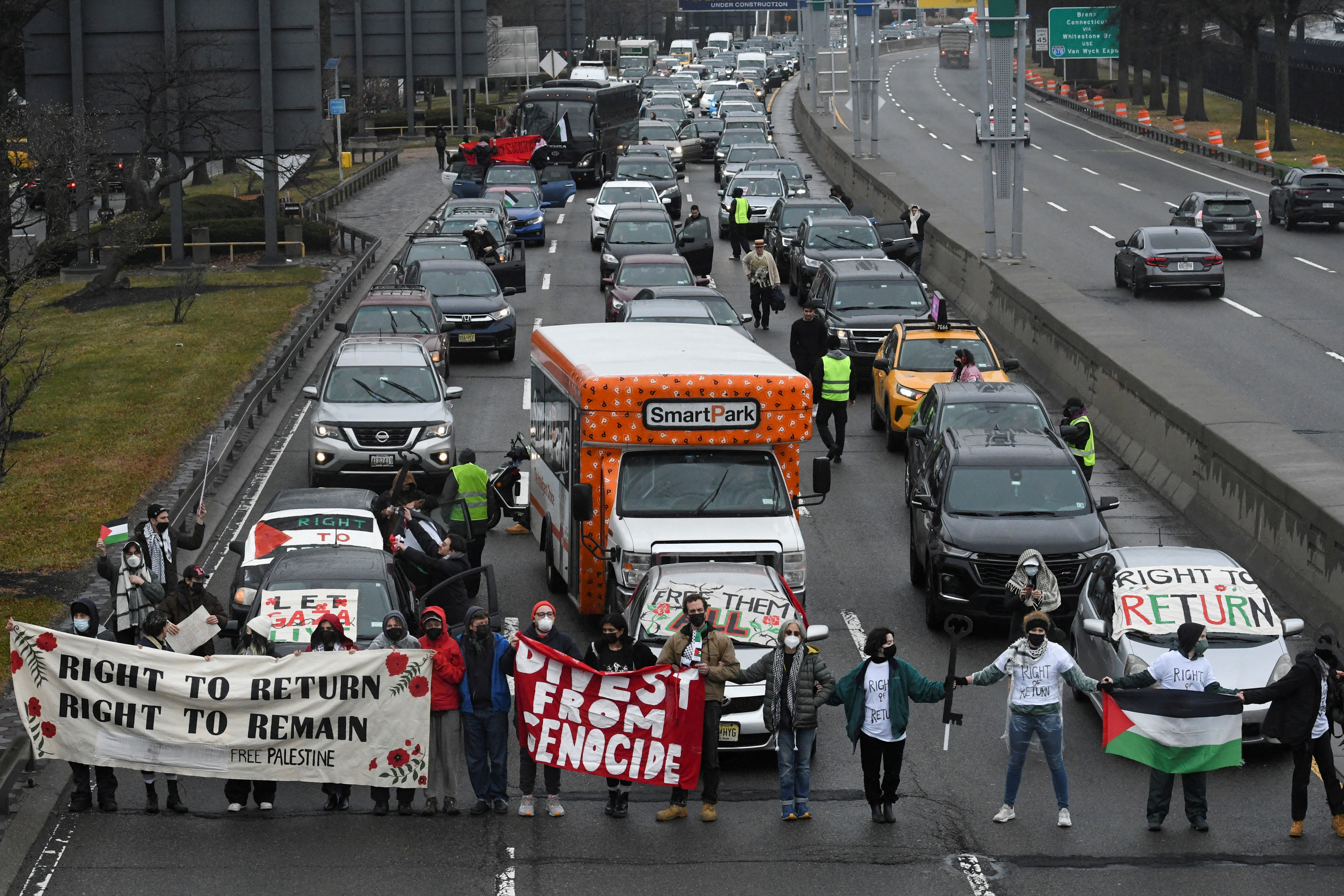 Pro-Palestinian demonstrators block traffic on the road that leads to John F Kennedy airport (JFK), in New York City