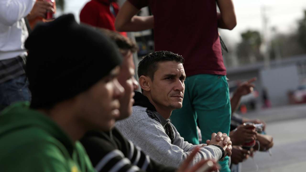Cubans stranded in Mexico stand outside the border bridge after Washington repealed a measure granting automatic residency to virtually every Cuban who arrived in the United States, in Nuevo Laredo