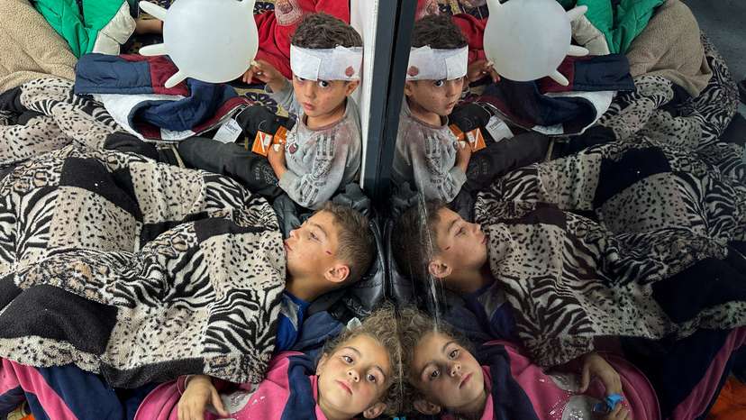 FILE PHOTO: Palestinian children wounded in an Israeli strike rest as they receive treatment at a hospital, in Rafah