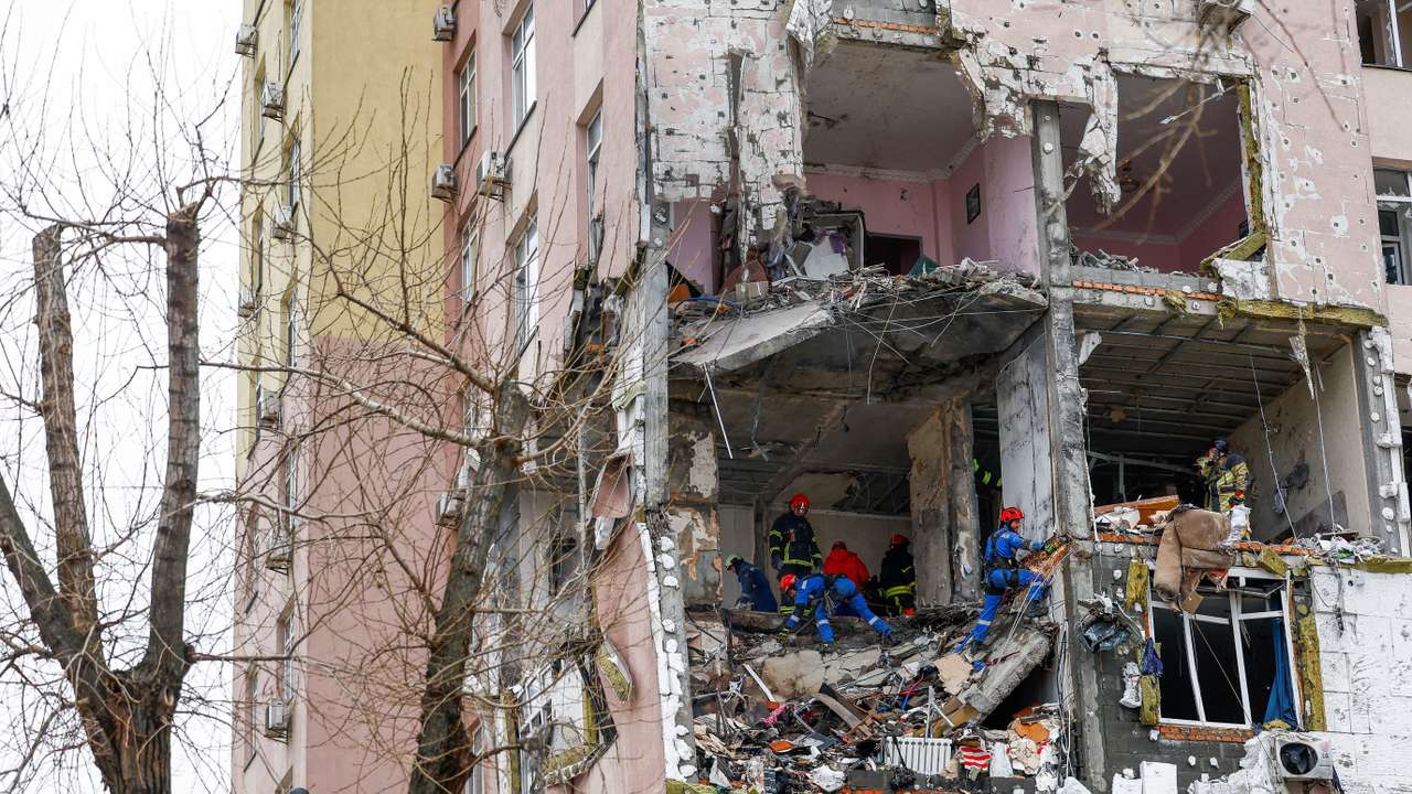 Firefighters work at the site of an apartment building hit during Russian missile and drone strikes, amid Russia’s attack on Ukraine in Kyiv