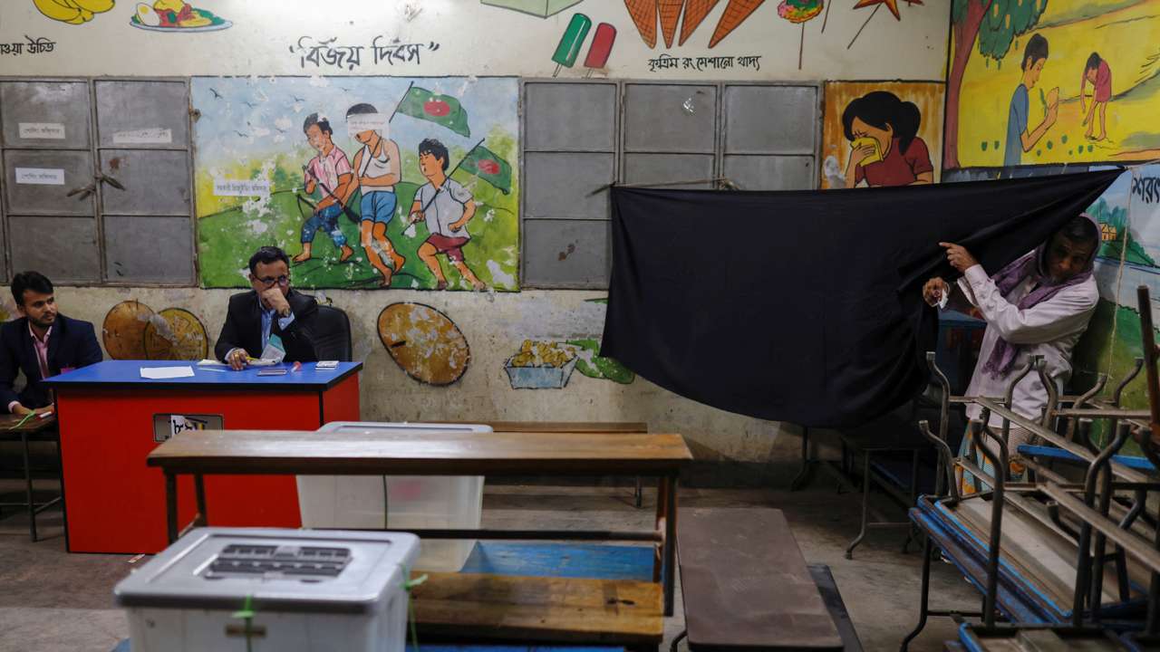 A voter comes out of a designated area after casting his vote during the 12th general election in Dhaka