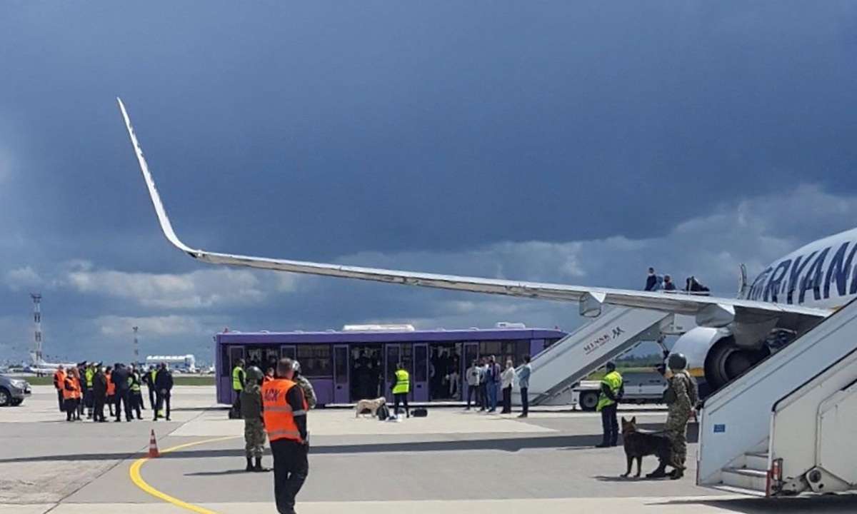 FILE PHOTO: Airport personnel and security forces are seen on the tarmac in front of a Ryanair flight which was forced to land in Minsk