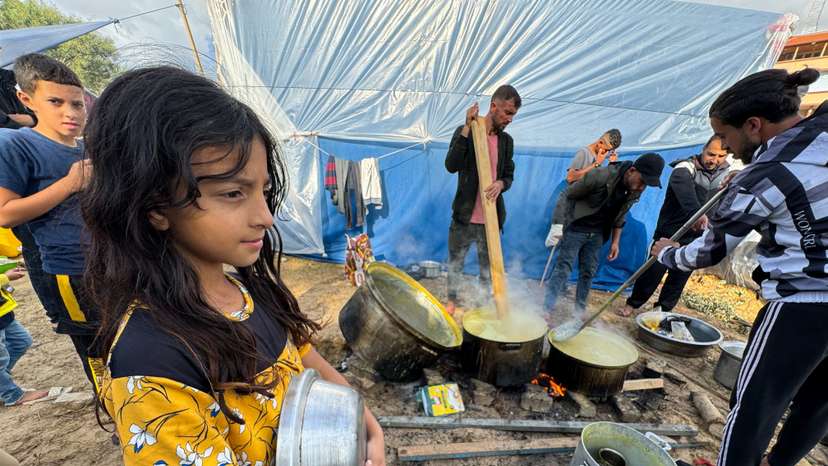 Displaced Palestinians, who fled their houses due to Israeli strikes, cook at Nasser Hospital in Khan Younis