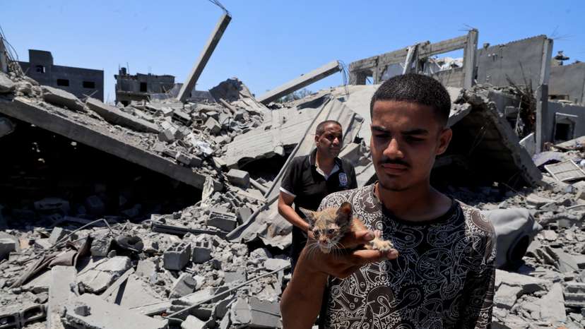 Palestinians inspect houses destroyed during an Israeli military operation, in Deir al-Balah