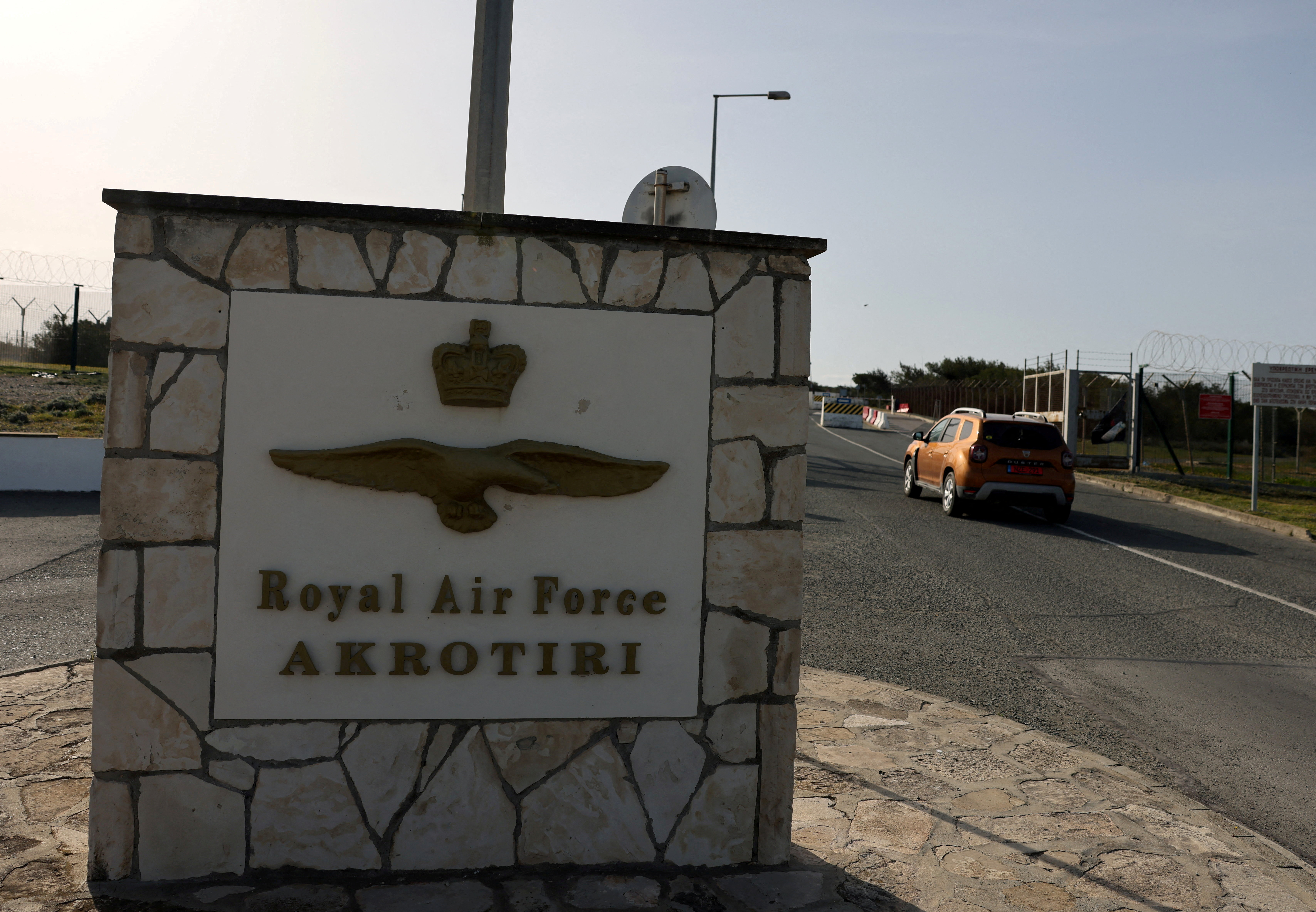 FILE PHOTO: A car drives in at the RAF Akrotiri, a British sovereign base in Cyprus that was hit by a drone early Monday, causing limited damage