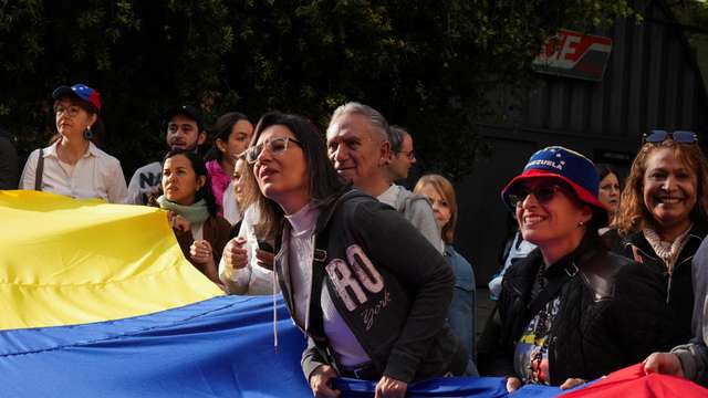 Venezuelans wait outside the consulate to vote on the day of  Venezuela's presidential election, in Mexico City