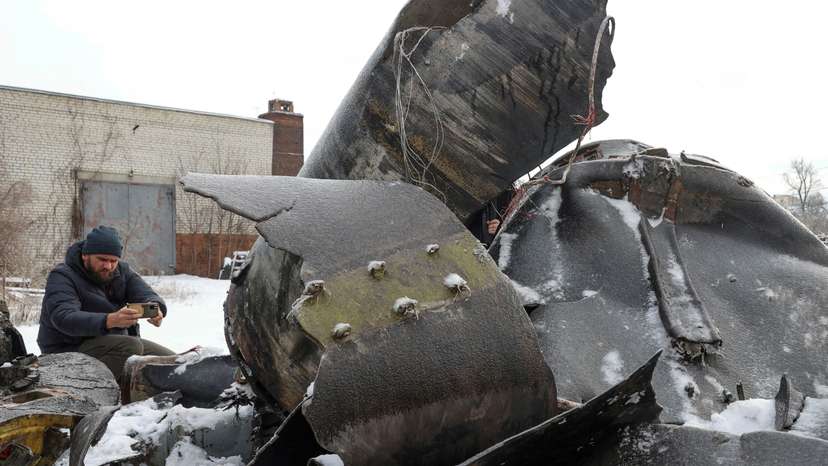FILE PHOTO: A man photographs parts of an unidentified missile, which Ukrainian authorities believe to be made in North Korea, in Kharkiv