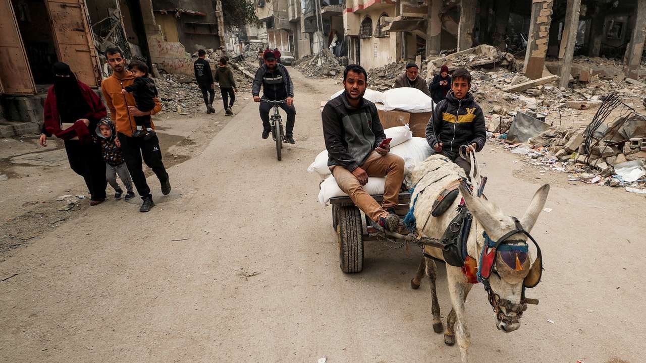 Palestinians wait to receive aid, in Gaza City