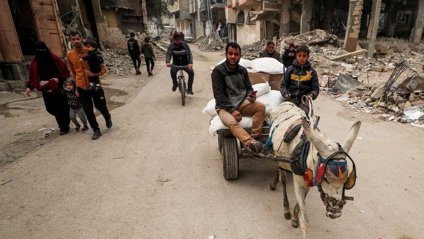 Palestinians wait to receive aid, in Gaza City