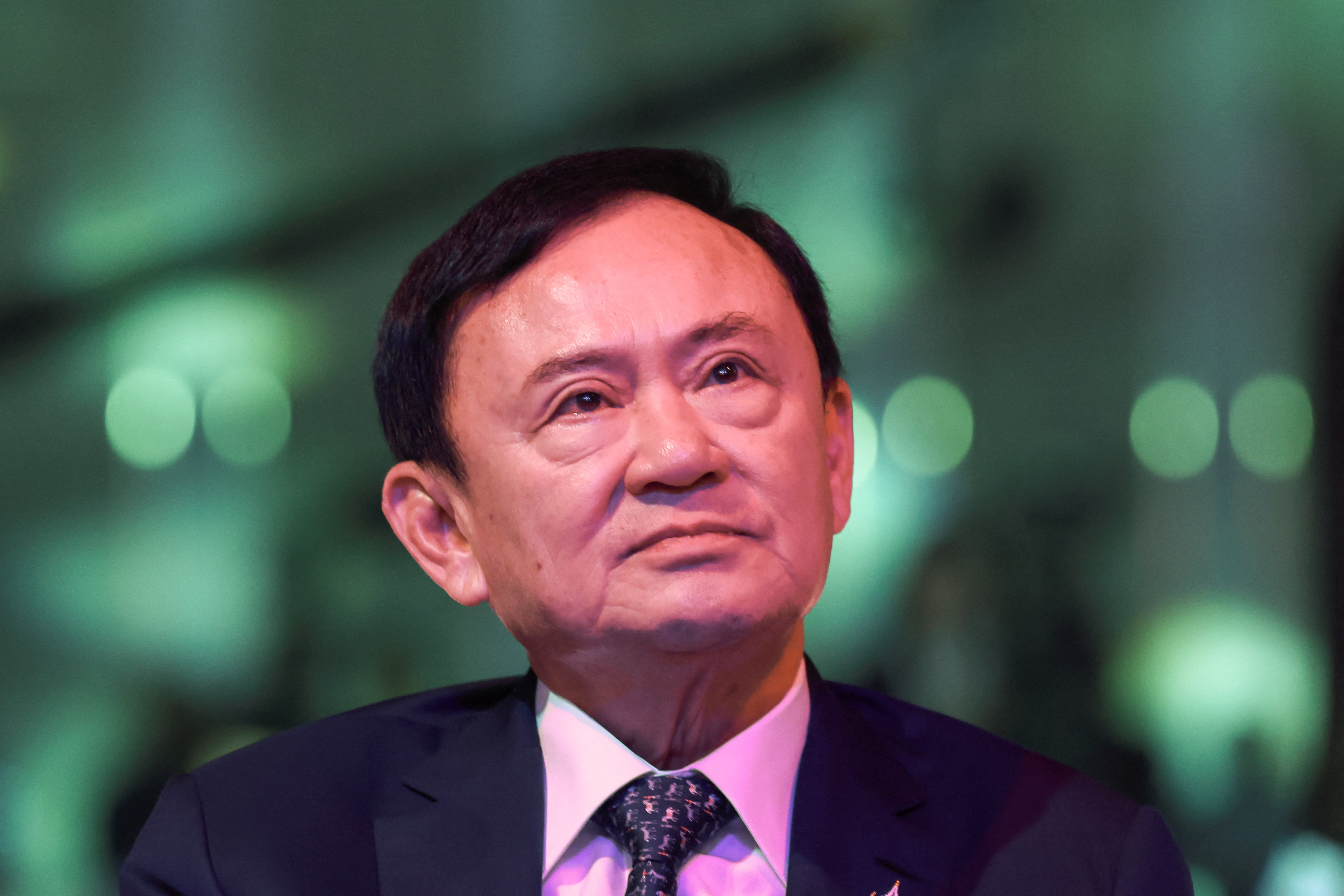 Thailand’s former Prime Minister Thaksin Shinawatra reacts ahead of a panel discussion with Thai broadcaster Nation TV, in Bangkok