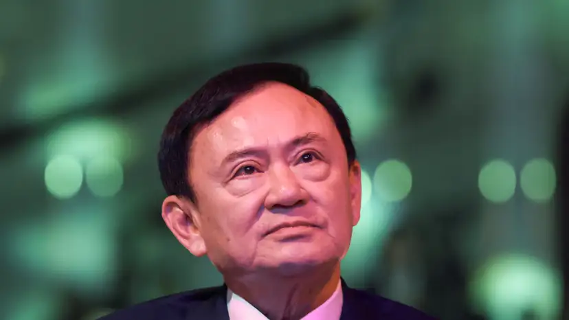 Thailand’s former Prime Minister Thaksin Shinawatra reacts ahead of a panel discussion with Thai broadcaster Nation TV, in Bangkok