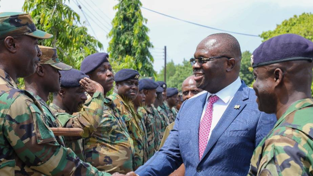 An image of Dr. Edward Omane Boamah with military officers