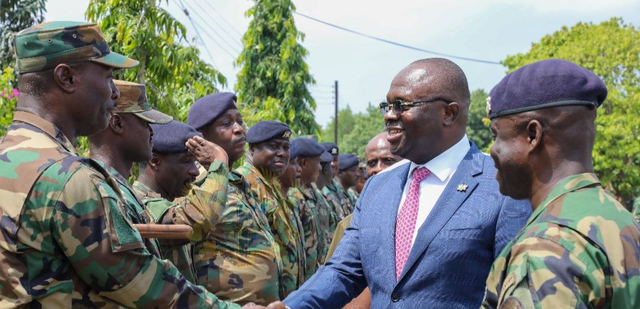 An image of Dr. Edward Omane Boamah with military officers