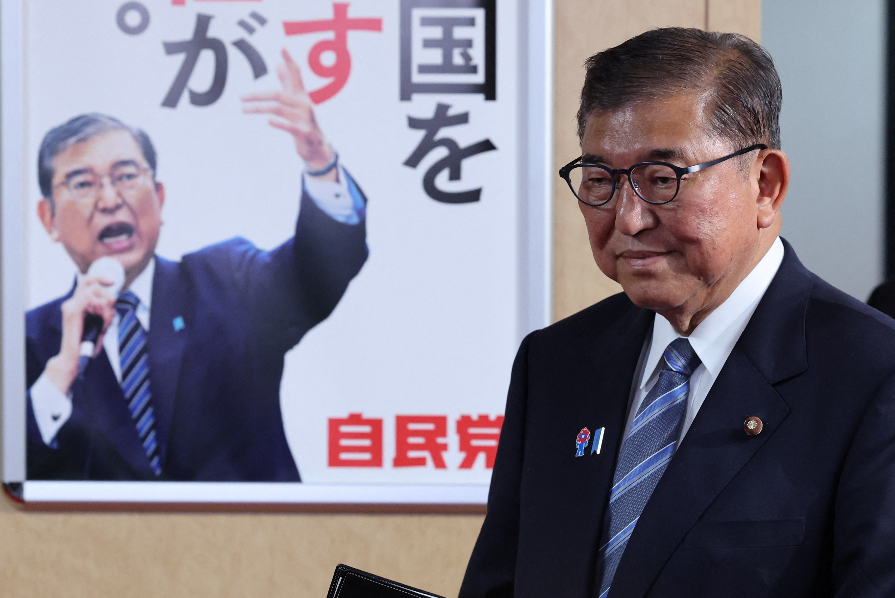 Japan's Prime Minister Ishiba speaks to media after meeting with the party's executives at the LDP headquarters in Tokyo