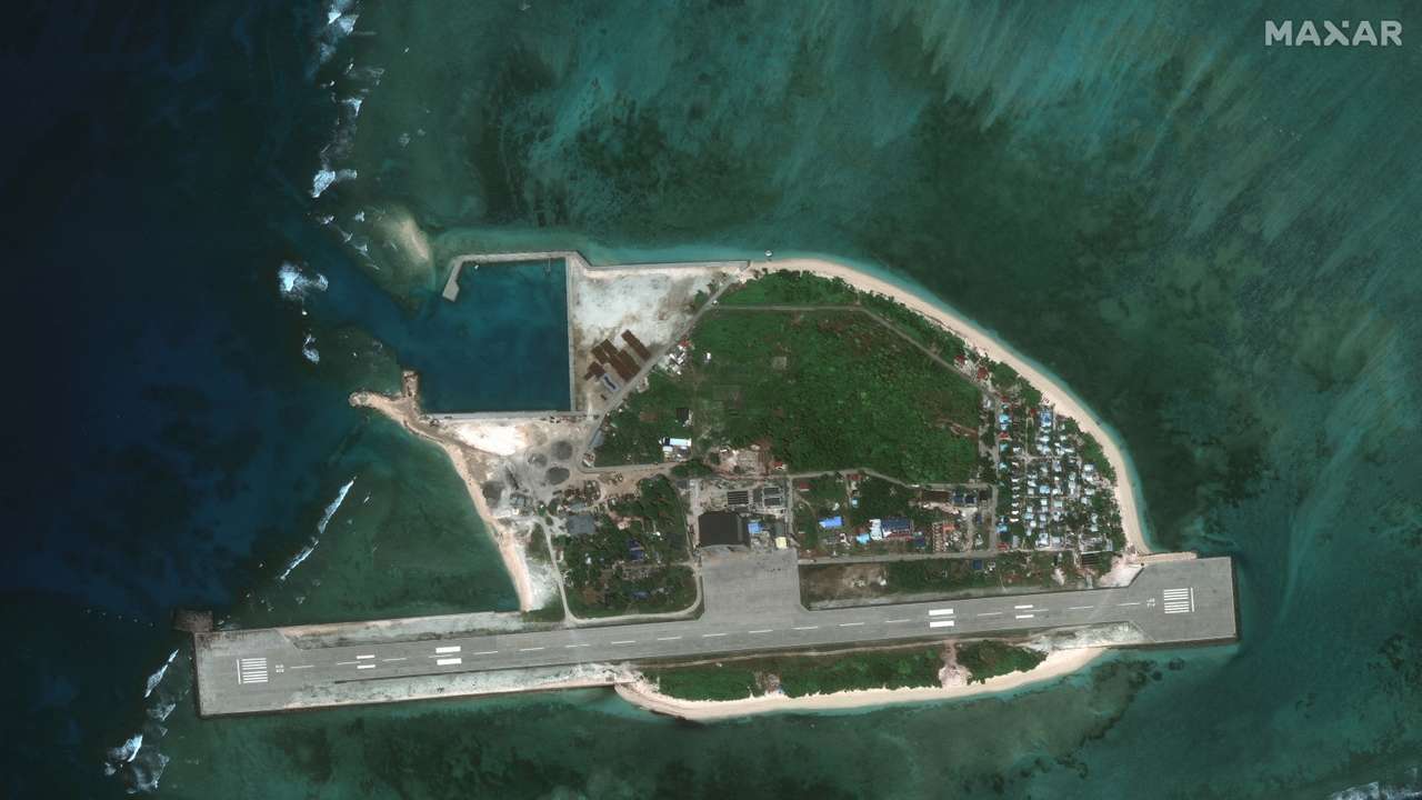 A satellite image appears to show an overview of Thitu Island and a fishing fleet, in the South China Sea