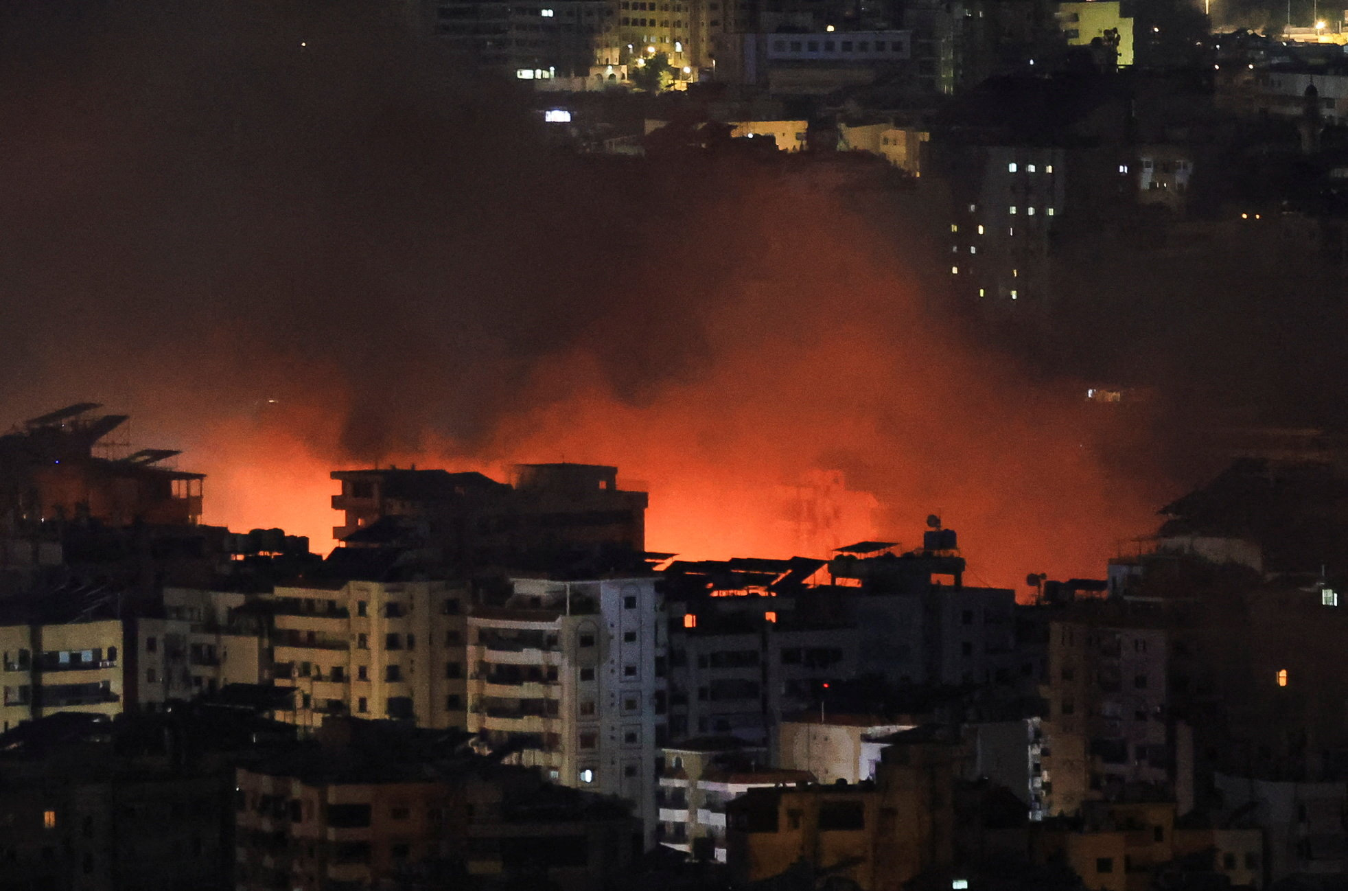 Smoke billows after reported strikes on Beirut's southern suburbs, as seen from Baabda
