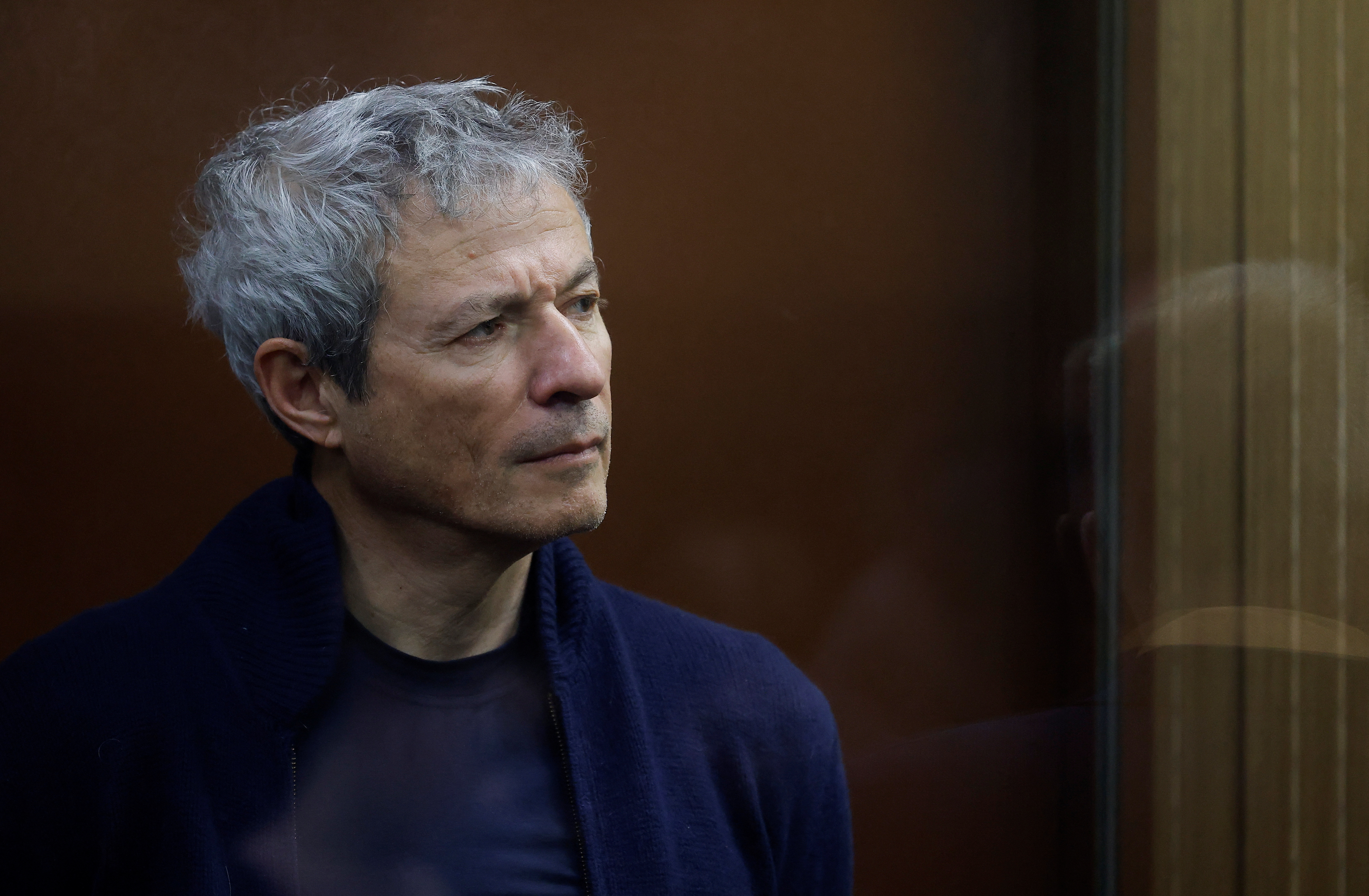 Vadim Moshkovich, founder of the country's top agriculture company Rusagro, stands inside a defendants' cage during a court hearing in Moscow