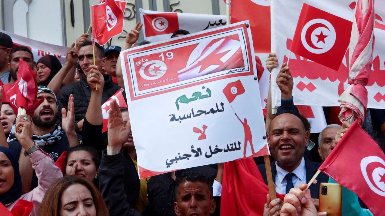 FILE PHOTO: Supporters of Tunisian President Kais Saied carry flags and signs during a demonstration in Tunis